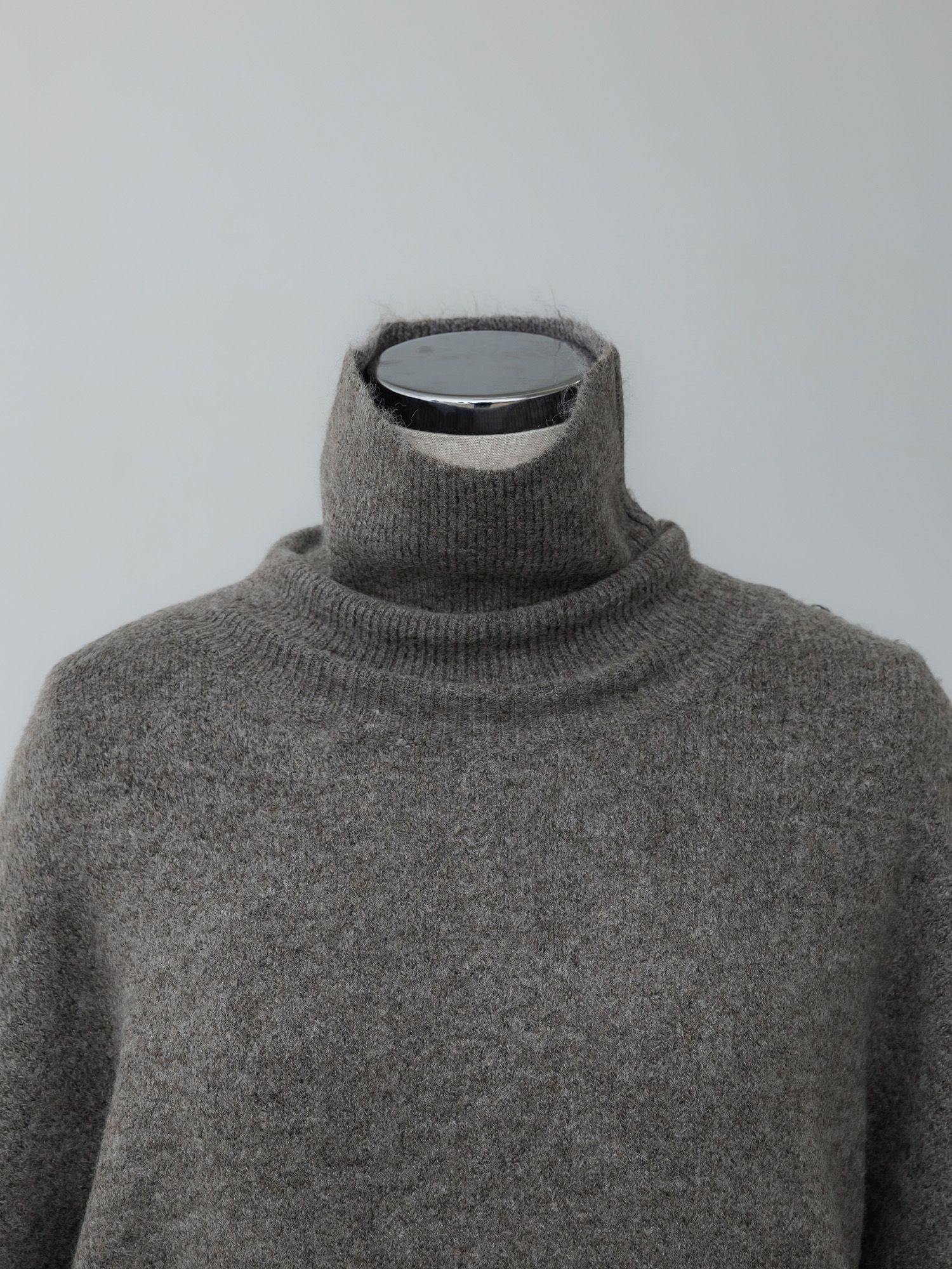 メランジハイネックルーズニット